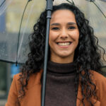 Woman smiling in the rain in Richardson and [test_shortcode]